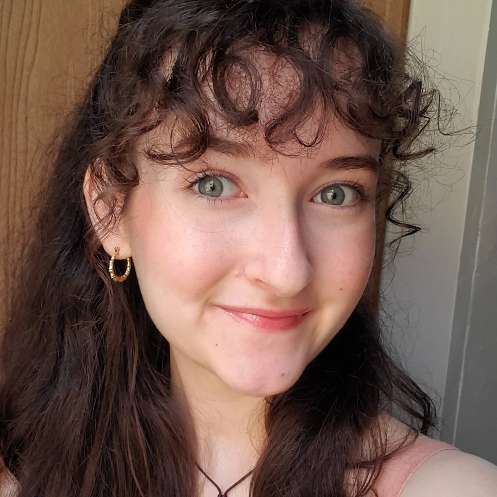 Smiling woman with curly brown hair